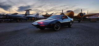 Pristine exterior profile of the KITT Knight Rider replica car highlighting the glossy black paint and classic 1983 Pontiac Trans Am body